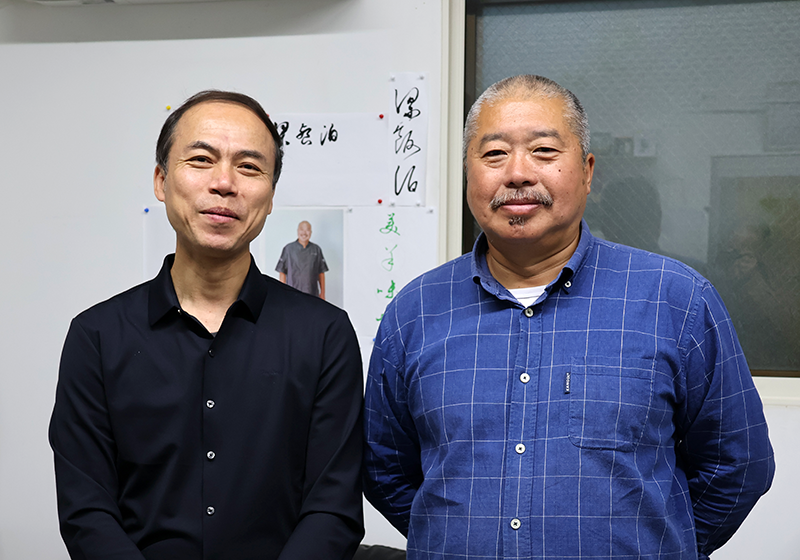 「味坊集団」代表の梁宝璋と専務取締役の林強